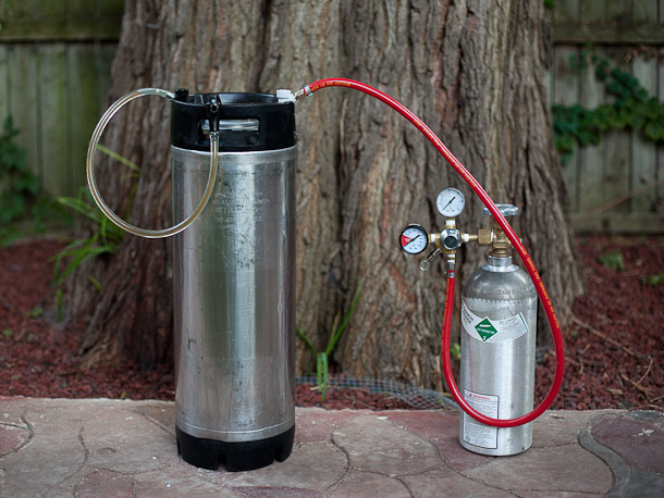 Ball lock keg with a picnic tap hooked up to a regulator